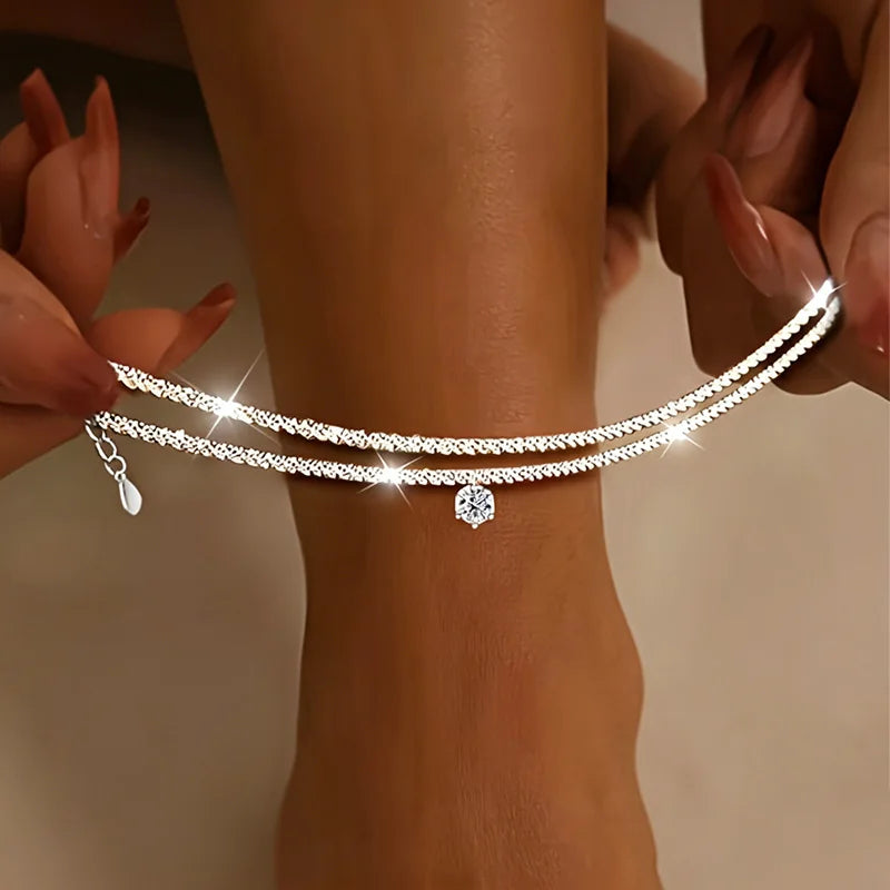 Fotlänksset med zirkonia i våg- och flätad design
