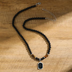 Tigeröga halsband herr – svart sten & geometriskt hänge