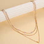 Halsband dam – flerlager halsband med hjärta i guldton